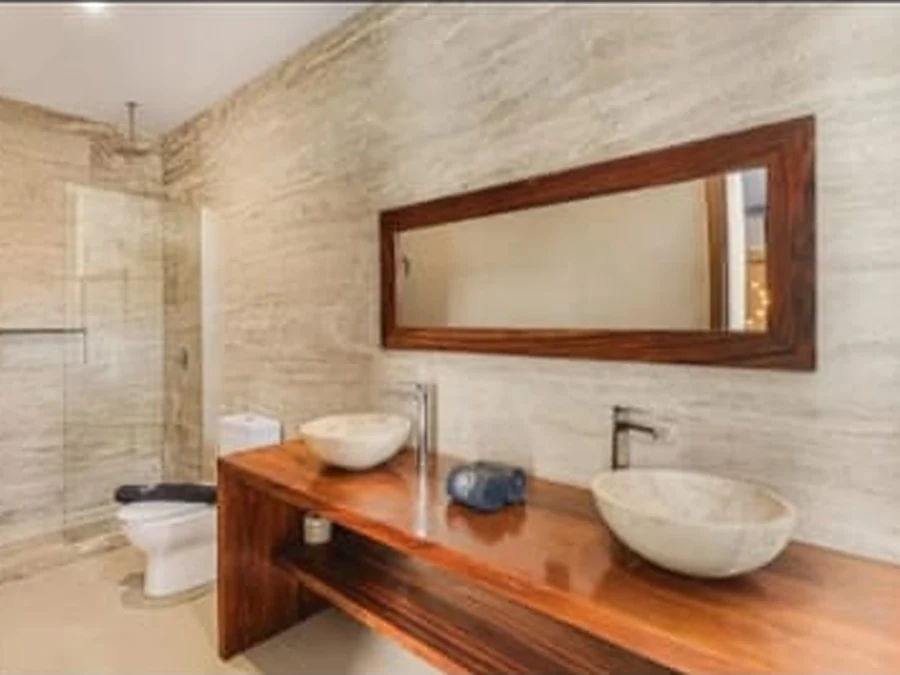 Bathroom with double stone basins and a walk-in shower