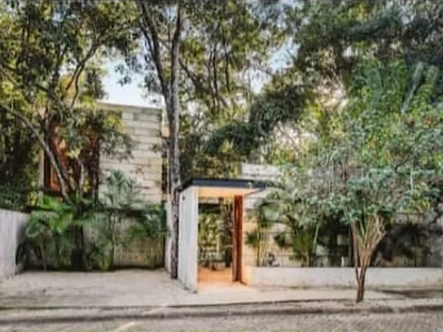 The villa entrance among the trees